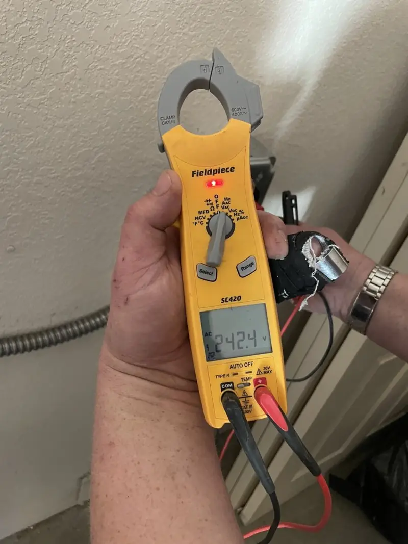 Voltage testing with clamp meter during Outlet Installation in Lyndon